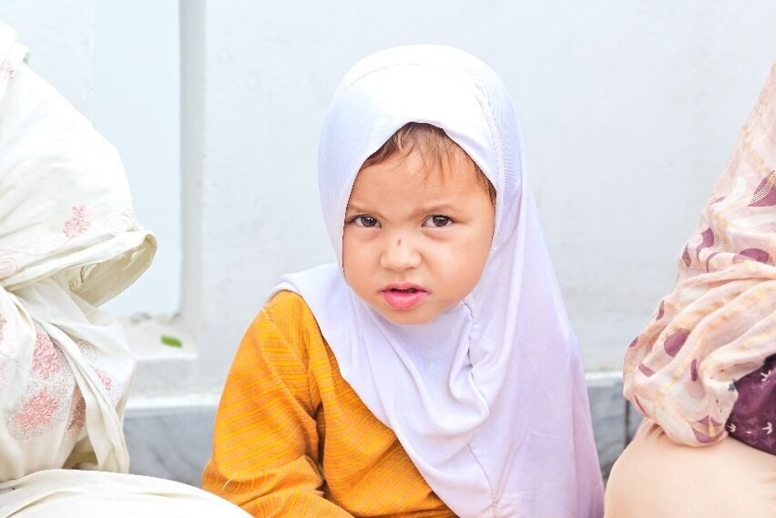 hungry child eating rice food in Azad Kashmir after finishing school, food poverty. hungry child eating rice food in Azad Kashmir after finishing school, food poverty.