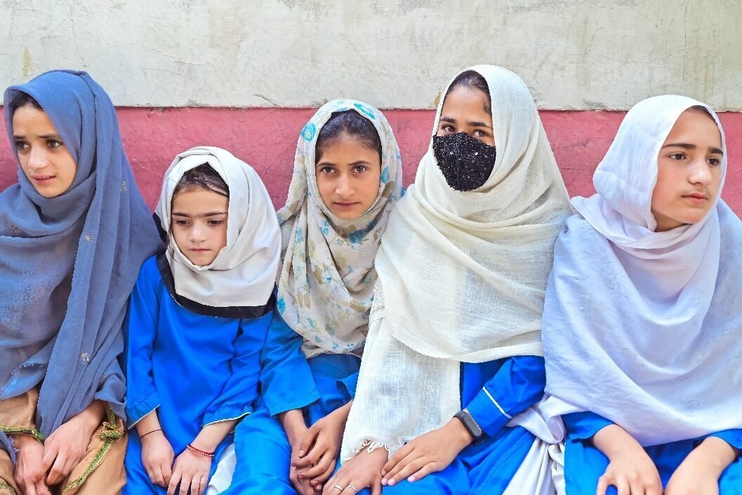 Kashmir School Girls sitting on a bench in near the Indian Kashmir border. Kashmir School Girls sitting on a bench in near the Indian Kashmir border.