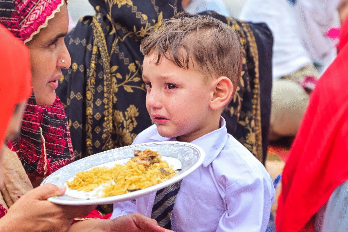hungry child eating rice food in Azad Kashmir after finishing school, food poverty. hungry child eating rice food in Azad Kashmir after finishing school, food poverty.