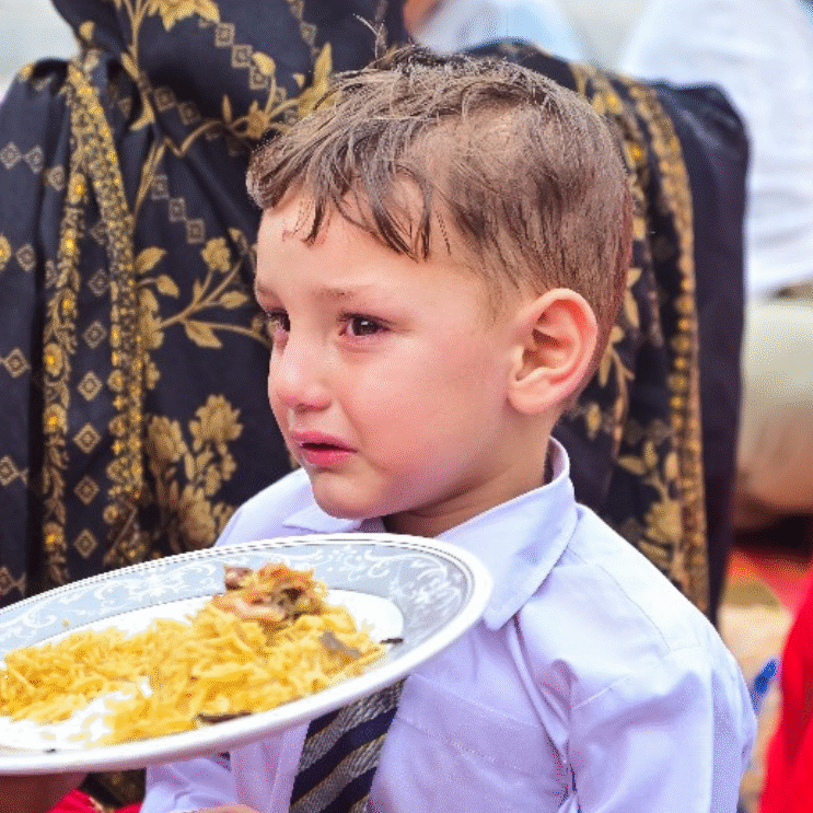 Hungry child eating rice food in Azad Kashmir