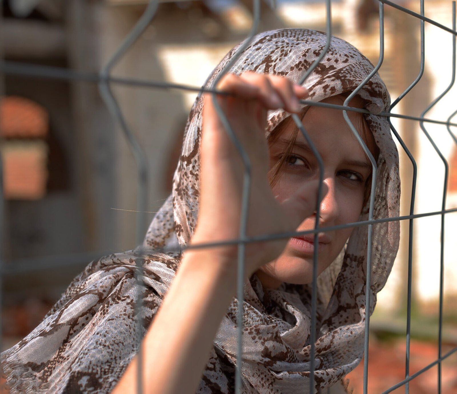 Selective focus shot of a white muslin refugee being held in captivity