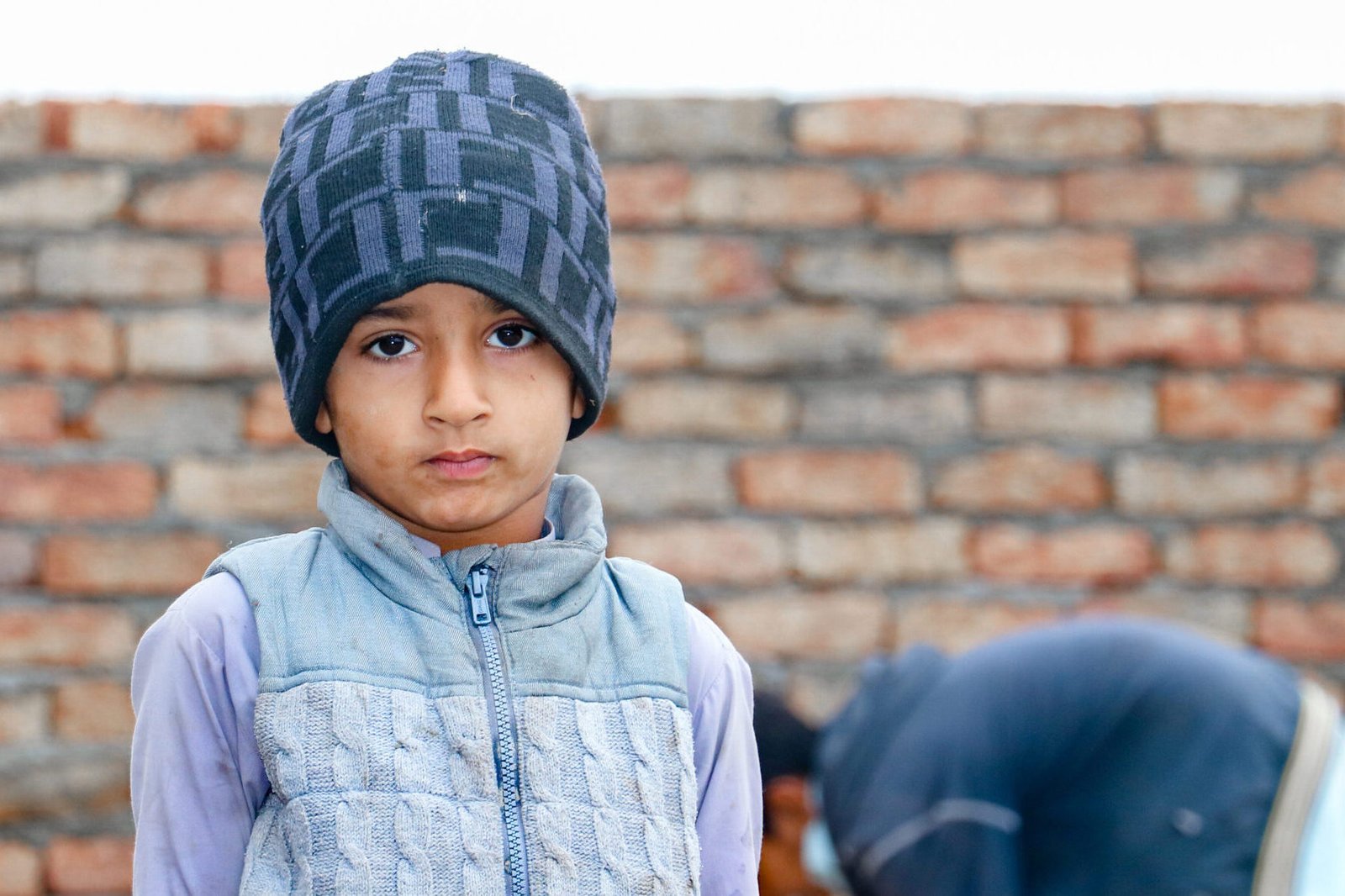 a child with a sad expression cause of flood and homelessness situation